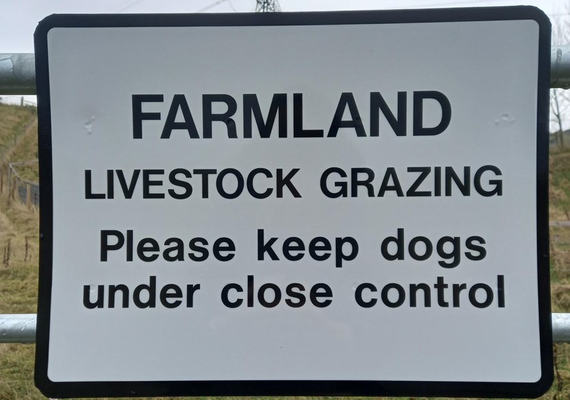 Farmland sign saying beware of dog